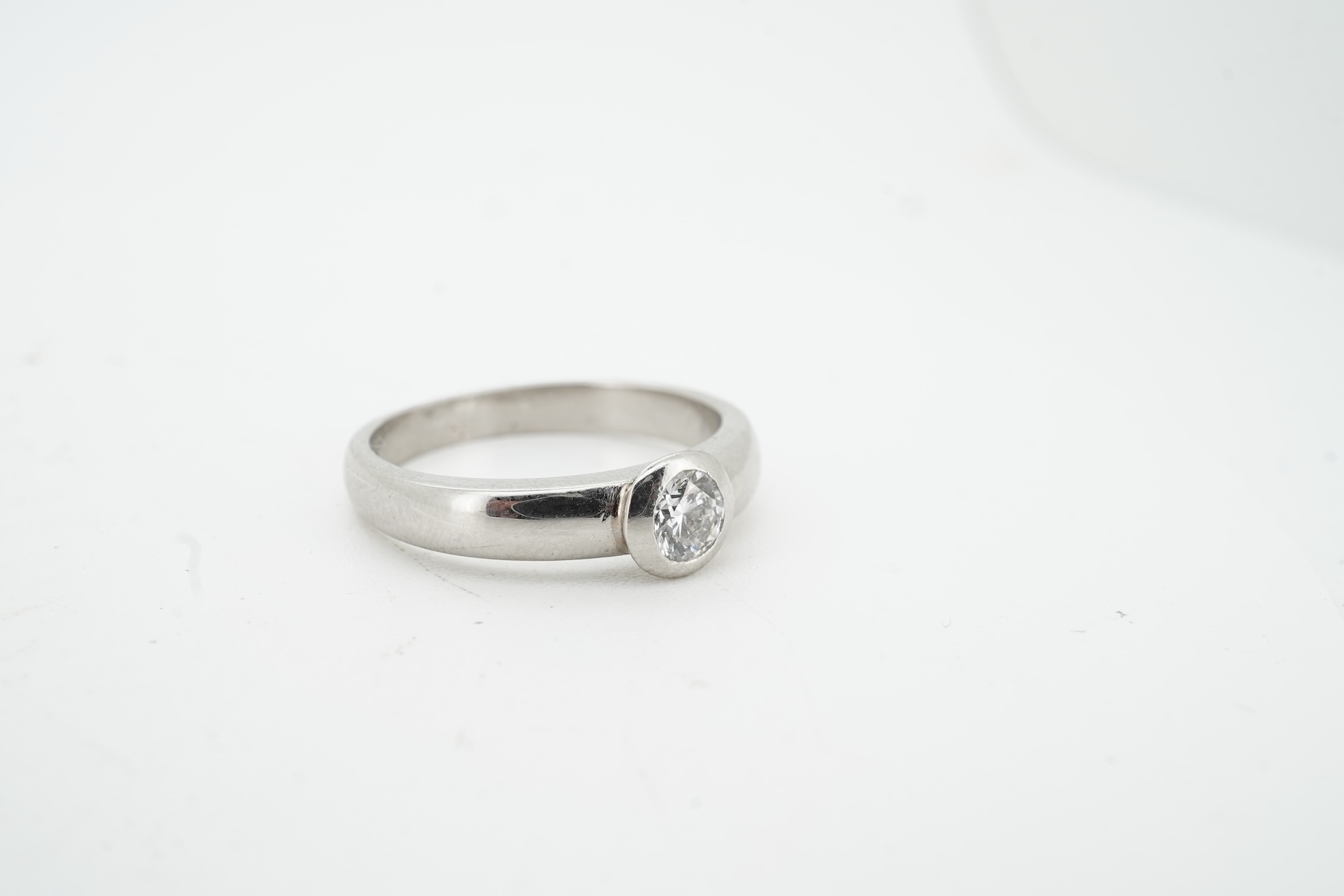 A diamond ring, collet-set with a brilliant-cut diamond weighing approximately 0.52 carats, mounted in platinum, size K1/2, British hallmarks, gross weight approximately 4 grams